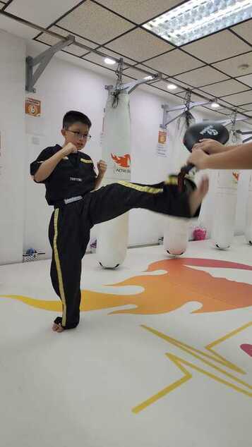 A boy practicing kickboxing
